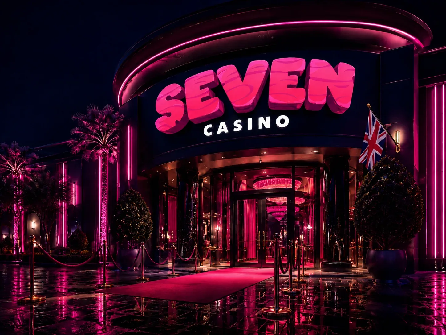 Brand entrance after dark Casino building at night with a lit brand sign, red carpet, rope barriers, palms and a Union Jack by the door